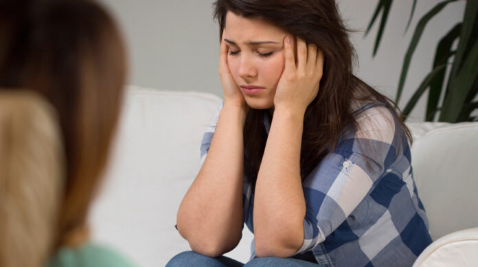 Depressed teenage talking to a counselor, psychiatrist or psychologist. Premature - Mother and Baby Matters